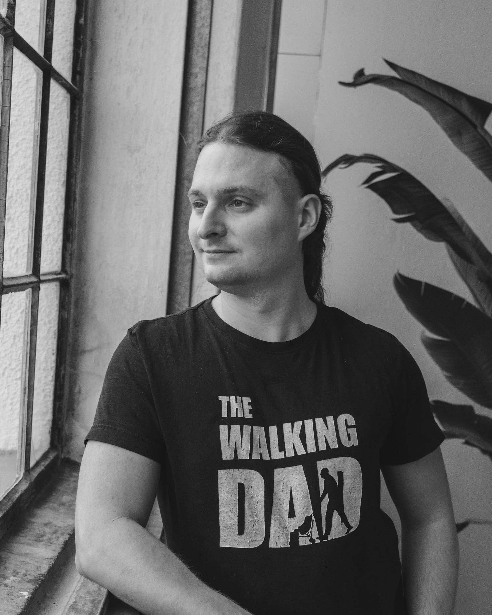 Martin Palounek by a window, in a black “The Walking Dad” T-shirt.